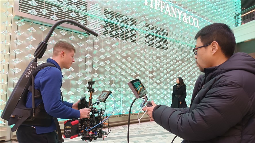 Wuhan production team discussing a brief near a location setup